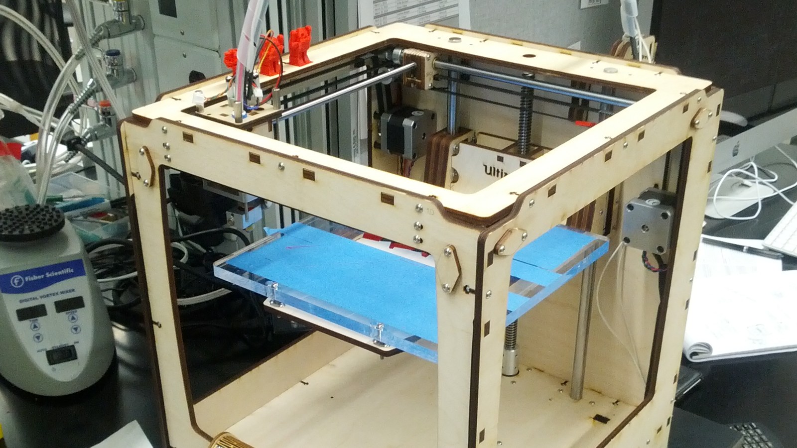 Desktop FDM printer on a bench, no operator