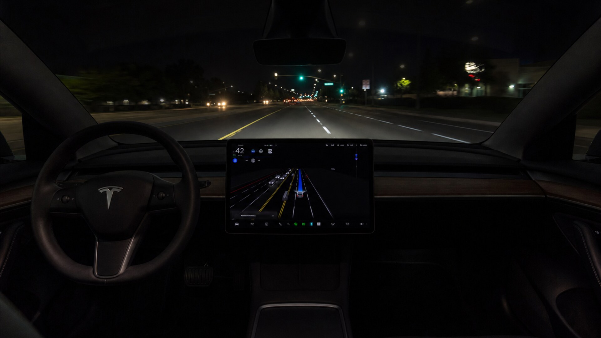 Tesla cabin at night with FSD on the screen